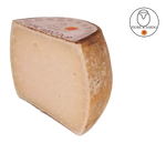 A slice of authentic Fiore Sardo DOP cheese, with its natural rind, reveals an intense aroma, evoking Sardinia.