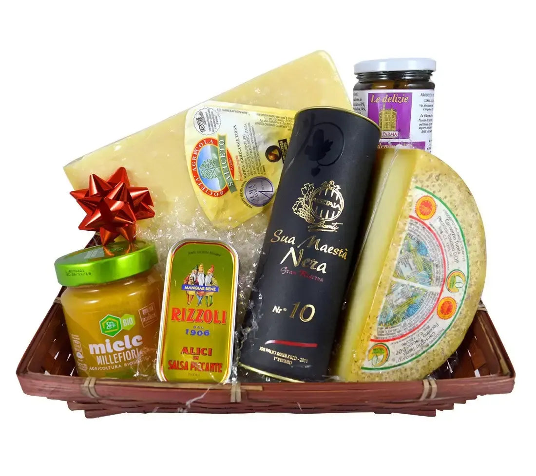 Un assortimento di sapori italiani nel Cesto Toscanini con formaggi DOP, miele millefiori, alici piccanti e balsamico.