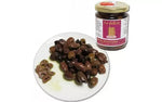 Degustazione di olive miste nel cesto Dino, abbinato a un barattolo di prelibatezze italiane per saporire l'autenticità.