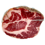 Una metà di Coppa di Parma IGP, stagionata per 2 mesi, mostra il suo taglio rosso e bianco, ideale per esaltare gustosi antipasti.
