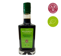 Biologica bottiglia di Aceto Balsamico di Modena IGP, contraddistinta da un'etichetta verde e i simboli IGP e biologico ben visibili.