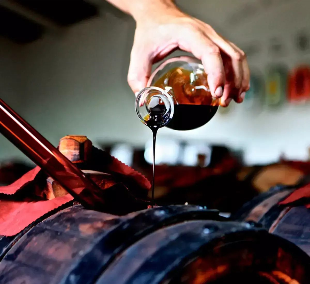 An image that tells the story of Italian craftsmanship: traditional balsamic vinegar of Modena, aged in wooden barrels, is poured.