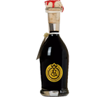 Un'elegante bottiglia di Aceto Balsamico Tradizionale DOP Reggio Emilia, impreziosita da un sigillo d'oro, tappi di cera rossa su vetro scuro.