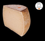 Metà di una forma di autentico Fiore Sardo DOP, un formaggio di pecora stagionato dal sapore sardo ricco e aromatico, su sfondo nero.