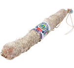 Un salame artigianale legato a mano, posato su una tavola rustica, è l'aggiunta ideale al tuo banchetto natalizio.