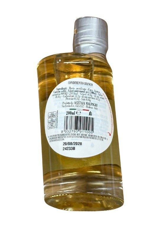 Terra & Mare offre una bottiglia di condimento bianco in un packaging di classe, esaltando ingredienti italiani per piatti gourmet.