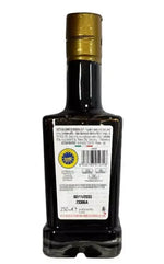 Edizione limitata della bottiglia di aceto balsamico 'Il Pinzimonio', un gioiello per i gourmet. L'etichetta è ricca di dettagli, esaltando la sua eleganza.