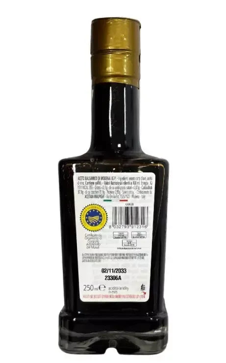 Edizione limitata della bottiglia di aceto balsamico 'Il Pinzimonio', un gioiello per i gourmet. L'etichetta è ricca di dettagli, esaltando la sua eleganza.