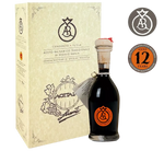 Una scatola accanto a una bottiglia di Autentico Aceto Balsamico Tradizionale di Reggio Emilia, etichettato come invecchiato per 12 anni, su uno sfondo luminoso.