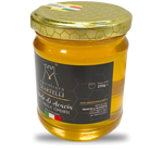Un barattolo trasparente da 250g di miele d'acacia dell'Apicoltura Martelli, l'oro liquido delle Prealpi Lombarde, con etichetta.